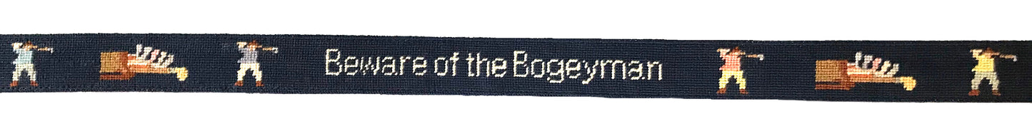 Golf belt layout featuring golf clubs and golfer on navy blue background.