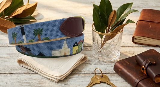 porch scene with needlepoint belt and magnolia leaves and leather books and journals