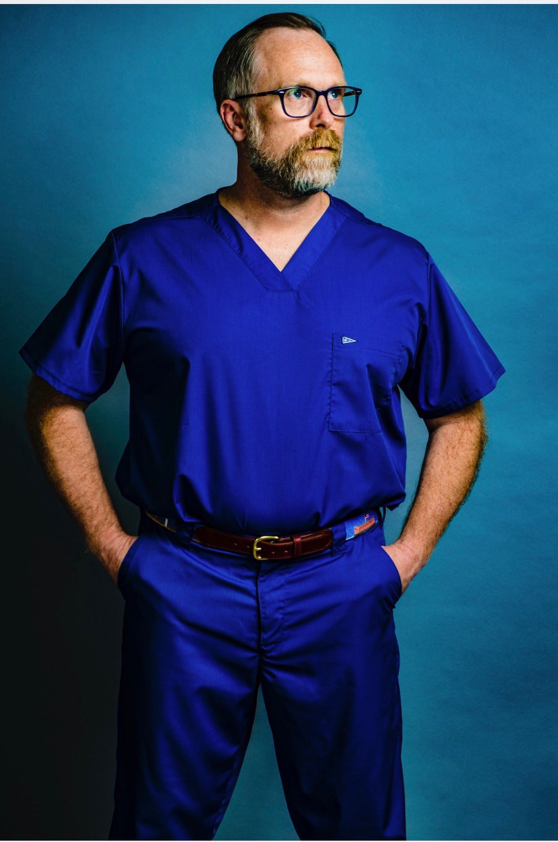 Dr Trey Clark wearing Saltwater Scrubs and Charleston Belt Charleston Scene needlepoint belt.