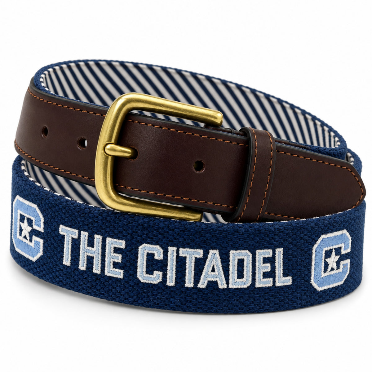 A woven navy blue belt with white embroidered text reading 'THE CITADEL' and light blue 'C' logos with white stars, paired with a brown leather strap and gold buckle.