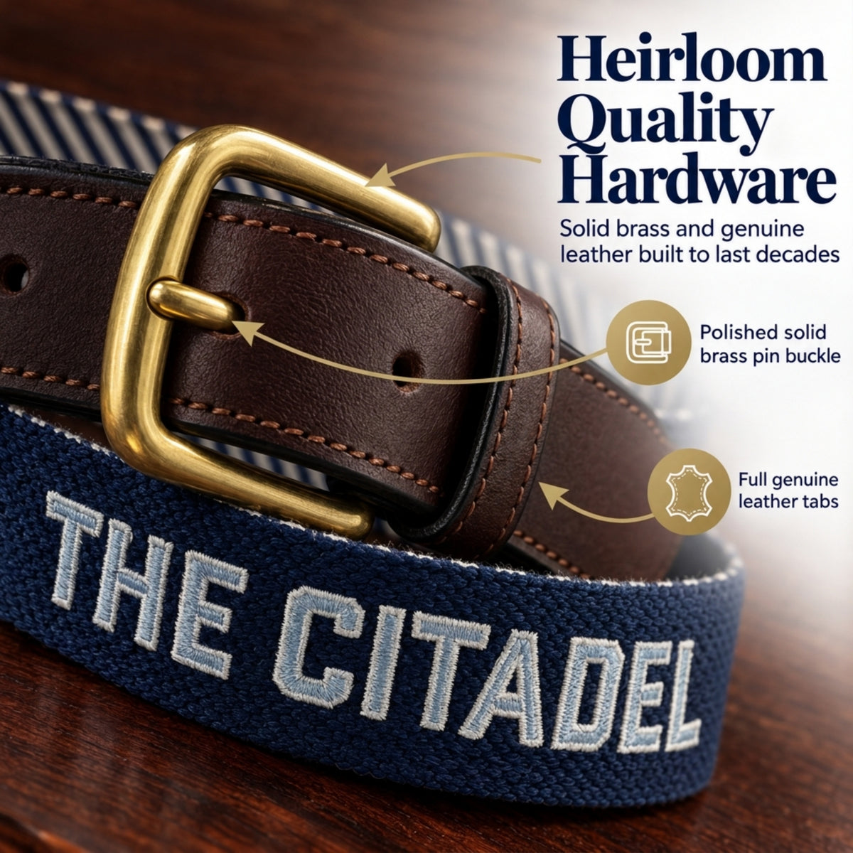 A close-up of a woven navy belt with white embroidered 'THE CITADEL' lettering, a dark brown leather strap, and a polished brass buckle. The image includes marketing text callouts highlighting the brass hardware and genuine leather tabs, set against a dark wood background.