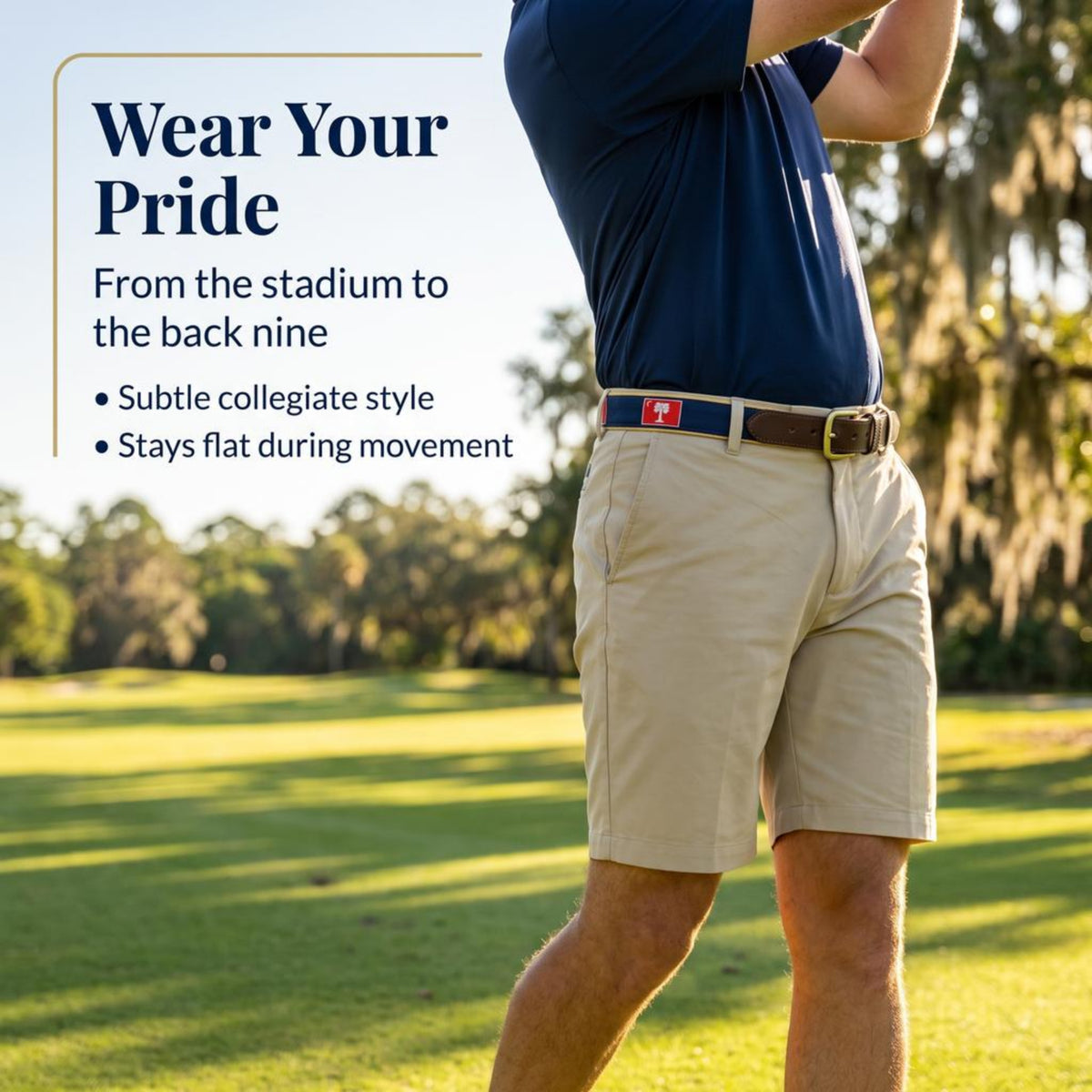 A man wearing khaki golf shorts, a navy polo shirt, and a blue-and-white belt stands on a sunny golf course with trees in the background. Text on the left reads, 'Wear Your Pride From the stadium to the back nine' with bullet points about subtle collegiate style and flat movement.