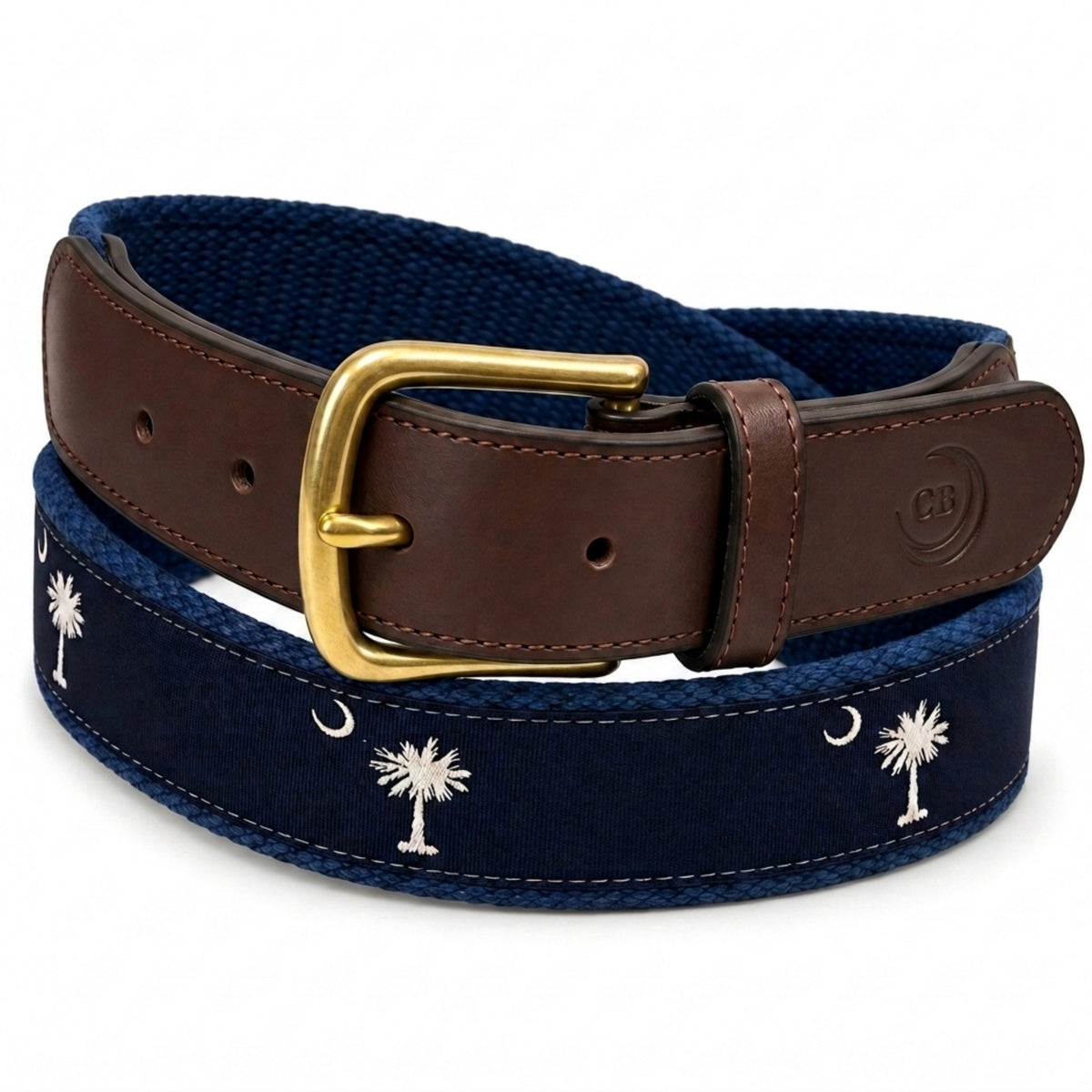 A South Carolina flag crescent and palmetto belt featuring a navy blue canvas body with white palm tree and crescent moon embroidery, a brown leather strap, and a gold buckle.