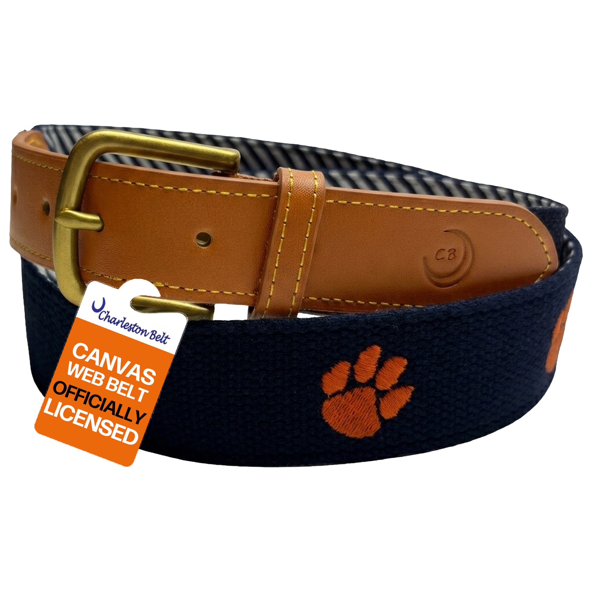 A Charleston Belt featuring a navy blue canvas strap with an orange paw print logo, a tan leather buckle, and a gold-tone metal buckle, shown with an orange and white tag.  Clemson Tigers officially licensed logo team name.
